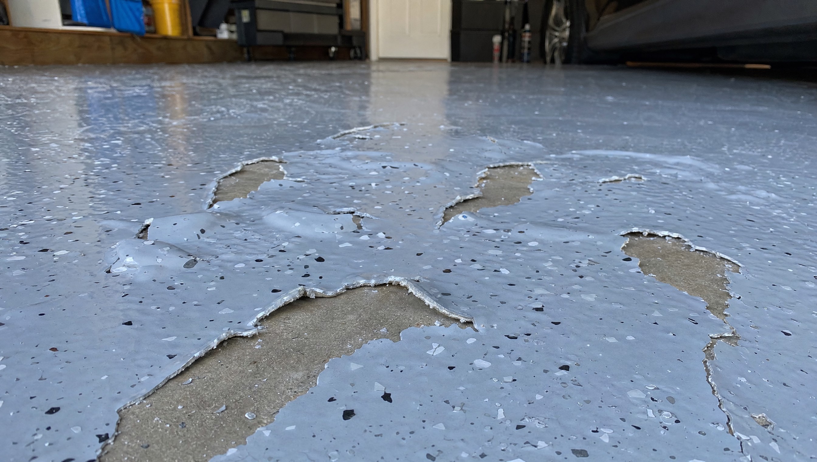 Failed DIY epoxy garage floor coating peeling and bubbling in Nashville garage